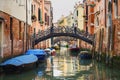 A bridge across the canal in Venice, Italy, Europe. Colorful buildings and typical Venice gondolas. Venezia.