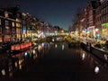 Canals and houses of Amsterdam city at night, in Holland, Netherlands Royalty Free Stock Photo