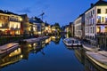 the canals are lit up by lights in the evening time