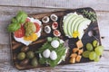 Canape with avocado, mozzarella ,tomato,pesto,olives, cream cheese.Mix snacks.On the desk Royalty Free Stock Photo