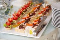 Canape with bacon. light snacks at the banquet. wooden handle.