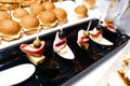 Canape with cheese, bacon and olives on the background of burgers