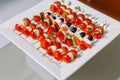 Canape. Cheese cubes with tomatoes, cucumbers, quail eggs, olives. Royalty Free Stock Photo