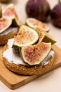 Canape or Crostini with Toasted Baguette Cream Cheese and Figs on Wooden Board Delicious Appetizer Lunch Yellow Background Close