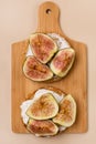 Canape or Crostini with Toasted Baguette Cream Cheese and Figs on Wooden Board Delicious Appetizer Lunch Yellow Background Top