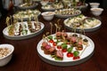 Different food snacks and appetizers in round plates on corporate event party. Celebration with catering banquet table. Royalty Free Stock Photo