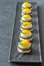 Canape with fried quail eggs Royalty Free Stock Photo