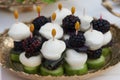 Canape with mozzarella cheese, cucumber, basil leaf and blackberry berry