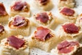 Canape with Pastrami / Pastirma Ham and Hummus on Small Square Bread. Royalty Free Stock Photo