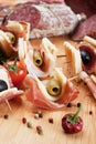 Canape with prosciutto and olives