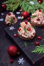 Canape shaped as a Christmas tree with pate garnished with pomegranate and dill