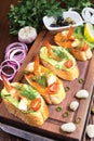 Canapes with avocado and squash caviar and garlic shrimps on crispy bread. A simple and light snack for parties and banquets. Royalty Free Stock Photo