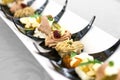 Canapes on black plastic spoons Royalty Free Stock Photo