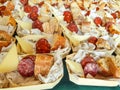 Canapes of ham, sausage and bread on a bamboo wooden tray. Image of hundreds of canapes prepared and ready to serve that fill the