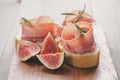 Canapes with jamon and figs on table Royalty Free Stock Photo