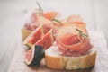 Canapes with jamon and figs on table Royalty Free Stock Photo