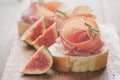 Canapes with jamon and figs on table Royalty Free Stock Photo