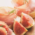 Canapes with jamon and figs on wooden board Royalty Free Stock Photo