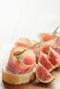 Canapes with jamon and figs on wooden board Royalty Free Stock Photo