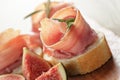 Canapes with jamon and figs on wooden board Royalty Free Stock Photo