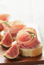 Canapes with jamon and figs on wooden board Royalty Free Stock Photo