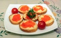 Canapes with red caviar on white plate Royalty Free Stock Photo