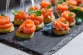 Canapes of red fish, bread, colored salt and herbs on skewers Royalty Free Stock Photo