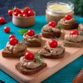 Canapes with rye bread, liver pate, cherry tomatoes. Breakfast snack Royalty Free Stock Photo