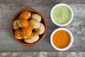 Canarian potatoes (papas arrugadas) with mojo sauce on wooden table Royalty Free Stock Photo
