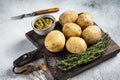 Canary Islands dish Papas Arrugadas, wrinkly potatoes with Mojo verde green sauce. White background. Top view Royalty Free Stock Photo