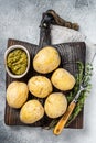 Canary Islands dish Papas Arrugadas, wrinkly potatoes with Mojo verde green sauce. White background. Top view Royalty Free Stock Photo