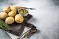 Canary Islands dish Papas Arrugadas, wrinkly potatoes with Mojo verde green sauce. White background. Top view. Copy Royalty Free Stock Photo