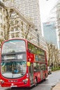 Canary wharf bay with buildings and thames river and very close red bus