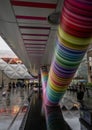 Canary Wharf, London, UK: Beneath the colorful Adams Place footbridge in London Docklands with people walking in the rain. Royalty Free Stock Photo