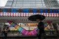 Canary Wharf, London, UK: Beneath the colorful Adams Place footbridge in London Docklands with people walking in the rain. Royalty Free Stock Photo