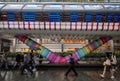 Canary Wharf, London, UK: Beneath the colorful Adams Place footbridge in London Docklands with people walking in the rain. Royalty Free Stock Photo