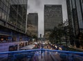 Canary Wharf, London, UK: Reuters Plaza in Canary Wharf with view to the JP Morgan building Royalty Free Stock Photo