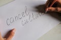 Cancel culture text written on white paper. Person eliminates letters holding a pencil. Cancel culture society concept Royalty Free Stock Photo