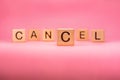 CANCEL word made with building blocks, business concept. Word CANCEL on pink background. Event cancellation. Cancelled