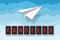 Canceled flight text with paper plane above the clouds in the sky