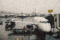 Canceled flight during weather conditions concept. Aircraft on gate under massive rain. Delay flight Royalty Free Stock Photo