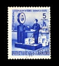 Cancelled postage stamp printed by Bulgaria, that shows Postman measuring packages on a scale Royalty Free Stock Photo