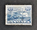 Cancelled postage stamp printed by Denmark, that shows Diesel-electric train `Lyntog` leaving ferry `Fyn`