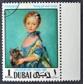 Cancelled postage stamp printed by Dubai, that shows Painting Young girl with kitten by Perroneau