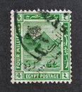 Cancelled postage stamp printed by Egypt, that shows Pyramids, Crown and Arabic letters overprint