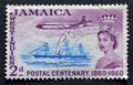 Cancelled postage stamp printed by Jamaica, that shows Queen Elizabeth II and Passenger-cargo ship