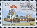 Cancelled postage stamp printed by Laos, that shows Parade, 15th Anniversary Of The People\'s Republic