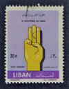 Cancelled postage stamp printed by Lebanon, that shows Hand making Scout sign