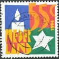 Cancelled postage stamp printed by Netherlands, that shows Candle and Star