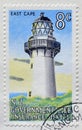 Cancelled postage stamp printed by New Zealand, that shows East Cape lighthouse